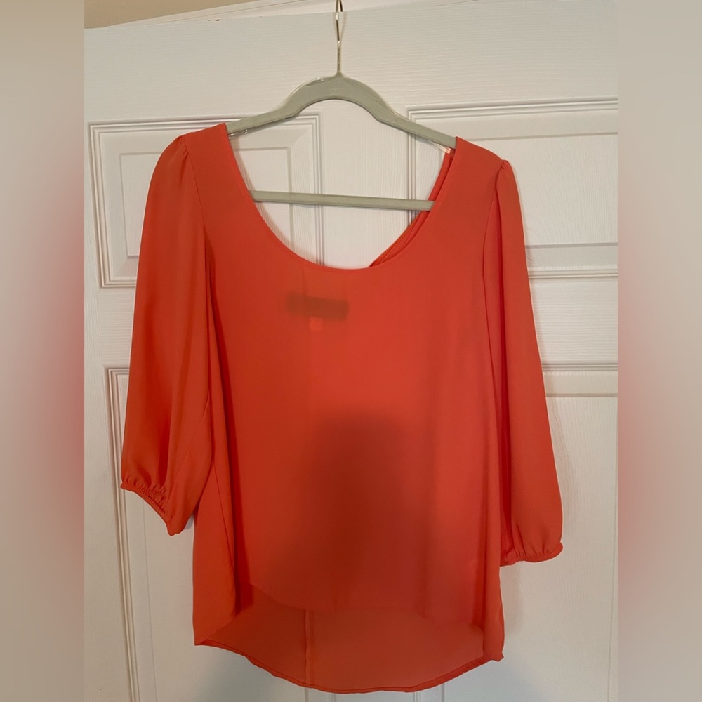 Francesca’s orange shirt